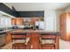 Open kitchen with stainless steel appliances, breakfast bar, and light wood cabinets at 10580 E Bella Vista Dr, Scottsdale, AZ 85258
