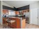 Bright kitchen featuring a breakfast bar, stainless steel appliances, and wood cabinetry at 10580 E Bella Vista Dr, Scottsdale, AZ 85258