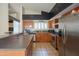 Well-lit kitchen with stainless steel appliances, a breakfast bar and wood cabinets at 10580 E Bella Vista Dr, Scottsdale, AZ 85258