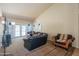 Bright living room featuring a large sofa, neutral walls, and patio access at 10580 E Bella Vista Dr, Scottsdale, AZ 85258