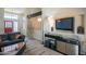 Open-concept living room featuring a large sofa, high ceilings, and a TV at 10580 E Bella Vista Dr, Scottsdale, AZ 85258