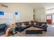 Vaulted living area featuring a large sofa and entry into the home at 10580 E Bella Vista Dr, Scottsdale, AZ 85258