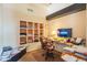 Comfortable office space featuring a built-in bookcase and an abundance of natural light at 10580 E Bella Vista Dr, Scottsdale, AZ 85258