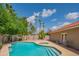Sparkling backyard pool surrounded by a tiled patio and mature landscaping, perfect for outdoor enjoyment at 10580 E Bella Vista Dr, Scottsdale, AZ 85258