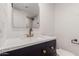 Modern bathroom featuring a sleek vanity with gold hardware, accented by a framed mirror at 10610 W Diana Ave, Peoria, AZ 85345