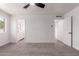 Bedroom with a ceiling fan and carpet, featuring easy access to an ensuite bathroom at 10610 W Diana Ave, Peoria, AZ 85345