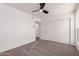 A well-lit bedroom with neutral carpet and a ceiling fan, conveniently located next to the closet at 10610 W Diana Ave, Peoria, AZ 85345