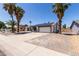 Charming single-story home with solar panels and desert landscaping, including palm trees at 10610 W Diana Ave, Peoria, AZ 85345