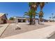 Lovely single-story home with solar panels, desert landscaping, and mature palm trees at 10610 W Diana Ave, Peoria, AZ 85345