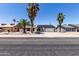 Charming single-story home with solar panels and desert landscaping, including palm trees at 10610 W Diana Ave, Peoria, AZ 85345