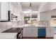 Bright kitchen with white cabinets, stainless steel appliances, and a window view of the backyard at 10610 W Diana Ave, Peoria, AZ 85345