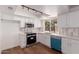 Modern kitchen with stainless steel appliances, bright white cabinets, and a stylish blue dishwasher at 10610 W Diana Ave, Peoria, AZ 85345