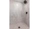 Modern shower featuring neutral tile, a rainfall shower head, and a contrasting dark fixture at 10610 W Diana Ave, Peoria, AZ 85345