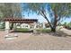 Outdoor living: a backyard fire pit, pergola, and stone accents at 10755 E Cholla Ln, Scottsdale, AZ 85259
