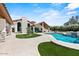 Beautiful backyard featuring a sparkling pool, lush landscaping, and a spacious patio for entertaining at 10755 E Cholla Ln, Scottsdale, AZ 85259