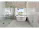 Stylish bathroom featuring a soaking tub, glass shower, and decorative tile at 10755 E Cholla Ln, Scottsdale, AZ 85259