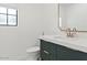 Modern bathroom features a sleek vanity with stylish fixtures and a designer mirror above, toilet with window above at 10755 E Cholla Ln, Scottsdale, AZ 85259