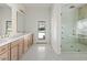 Bathroom features a double vanity, decorative tile flooring, and glass enclosed shower at 10755 E Cholla Ln, Scottsdale, AZ 85259