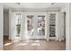 Bedroom featuring hardwood floors and French doors leading to the backyard at 10755 E Cholla Ln, Scottsdale, AZ 85259