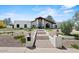 Home's grand entrance with manicured landscaping creating curb appeal at 10755 E Cholla Ln, Scottsdale, AZ 85259