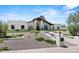 Beautiful home exterior with manicured lawn and desert rock landscaping at 10755 E Cholla Ln, Scottsdale, AZ 85259