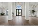 Bright foyer with hardwood floors, high ceilings, and large front doors at 10755 E Cholla Ln, Scottsdale, AZ 85259