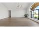 Bright living room with large windows, hardwood floors, and modern chandeliers at 10755 E Cholla Ln, Scottsdale, AZ 85259