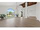 Spacious living area with expansive windows, hardwood floors, and modern chandeliers at 10755 E Cholla Ln, Scottsdale, AZ 85259