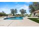 Inviting pool area with mature trees, custom stonework, lounge areas, and resort-style amenities in the backyard at 10755 E Cholla Ln, Scottsdale, AZ 85259