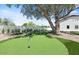 Backyard putting green for practice, framed by mature landscaping at 10755 E Cholla Ln, Scottsdale, AZ 85259