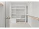 Spacious walk-in closet featuring custom shelving and ample storage at 10755 E Cholla Ln, Scottsdale, AZ 85259