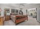 Bright bedroom featuring a wooden sleigh bed, a ceiling fan, and natural light at 1121 W Mission Dr, Chandler, AZ 85224