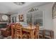Cozy dining area with natural wood table and chairs, bright window, and adjacent fireplace at 1121 W Mission Dr, Chandler, AZ 85224