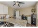 Bright home office with granite counters, ceiling fan, and neutral paint, providing a dedicated workspace at 1121 W Mission Dr, Chandler, AZ 85224