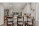 Bright kitchen with white cabinets, granite countertops, and a breakfast bar with stylish seating at 1121 W Mission Dr, Chandler, AZ 85224