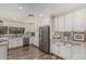 Spacious kitchen featuring a stainless steel refrigerator and sink with stylish granite countertops at 1121 W Mission Dr, Chandler, AZ 85224