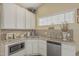 Efficient kitchen with white cabinets, stainless steel appliances, and granite countertops at 1121 W Mission Dr, Chandler, AZ 85224