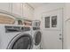 Convenient laundry room with modern washer and dryer, plus extra storage cabinets, ensuring efficient chores at 1121 W Mission Dr, Chandler, AZ 85224