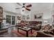 Spacious living room area with leather furniture, decorative fireplace, and sliding doors to the outdoor patio at 1121 W Mission Dr, Chandler, AZ 85224