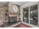 Cozy stone fireplace with wooden beam mantle and sliding glass doors to the outdoor pool area at 1121 W Mission Dr, Chandler, AZ 85224