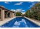 Stunning backyard with a beautiful blue pool, landscaping, and expansive patio area for outdoor enjoyment at 1121 W Mission Dr, Chandler, AZ 85224