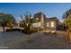 Beautiful backyard featuring a modern home, fire pit, decorative rock, and a covered patio seating area at 1211 E Hayward Ave, Phoenix, AZ 85020