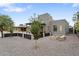 Inviting backyard featuring a modern home, fire pit, decorative rock, and a covered seating area at 1211 E Hayward Ave, Phoenix, AZ 85020