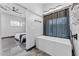 A minimalist bathroom featuring a modern soaking tub, sleek fixtures, and contemporary design at 1211 E Hayward Ave, Phoenix, AZ 85020