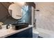 Modern bathroom with a black sink, white marble walls, and a soaking tub at 1211 E Hayward Ave, Phoenix, AZ 85020