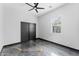 Bright bedroom showcasing dark marble-look floors, a ceiling fan, and stylish sliding closet doors at 1211 E Hayward Ave, Phoenix, AZ 85020