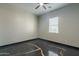 Bedroom featuring unique stained concrete flooring, ceiling fan, and a window at 1211 E Hayward Ave, Phoenix, AZ 85020