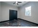 Modern bedroom featuring contemporary ceiling fan, black sliding door closet and bright window at 1211 E Hayward Ave, Phoenix, AZ 85020