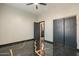 Bedroom featuring unique stained concrete flooring, ceiling fan, and sliding closet doors at 1211 E Hayward Ave, Phoenix, AZ 85020