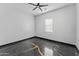 An airy, empty bedroom with dark marble-look floors and neutral walls, awaits personal touches at 1211 E Hayward Ave, Phoenix, AZ 85020